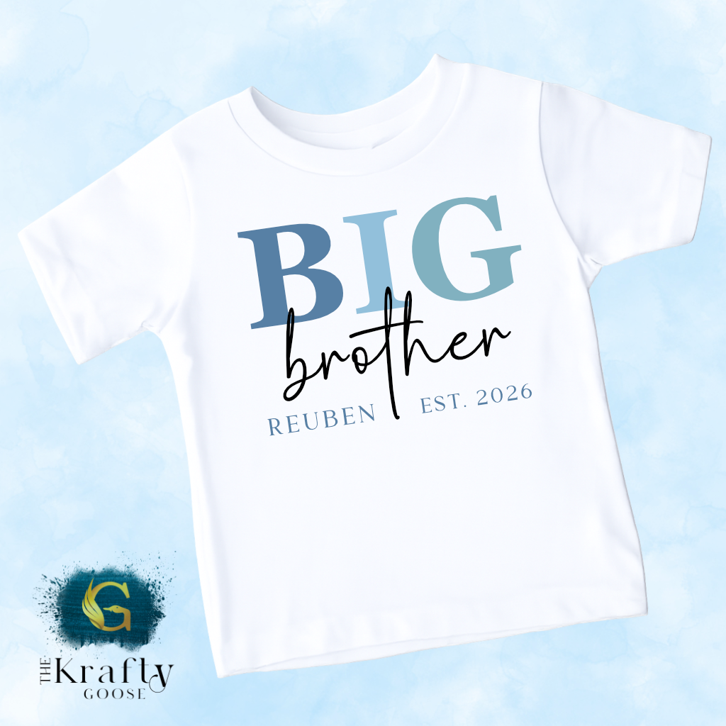 A white t-shirt with the text "BIG brother" printed on it, along with the text "REUben EST. 2026" below it.