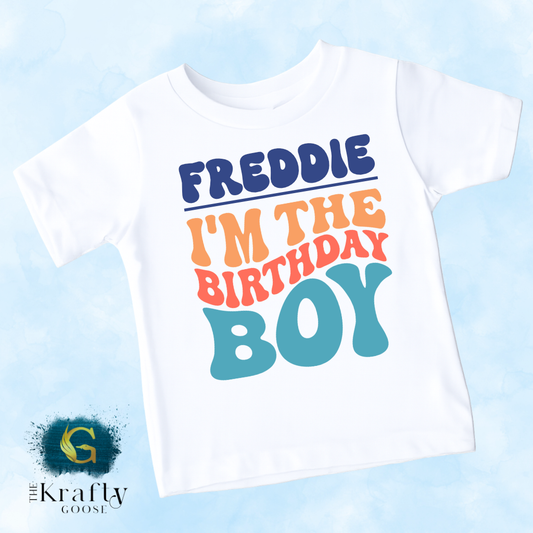 A white t-shirt with a colorful text design that says "FREDDIE I'M THE BIRTHDAY BOY".