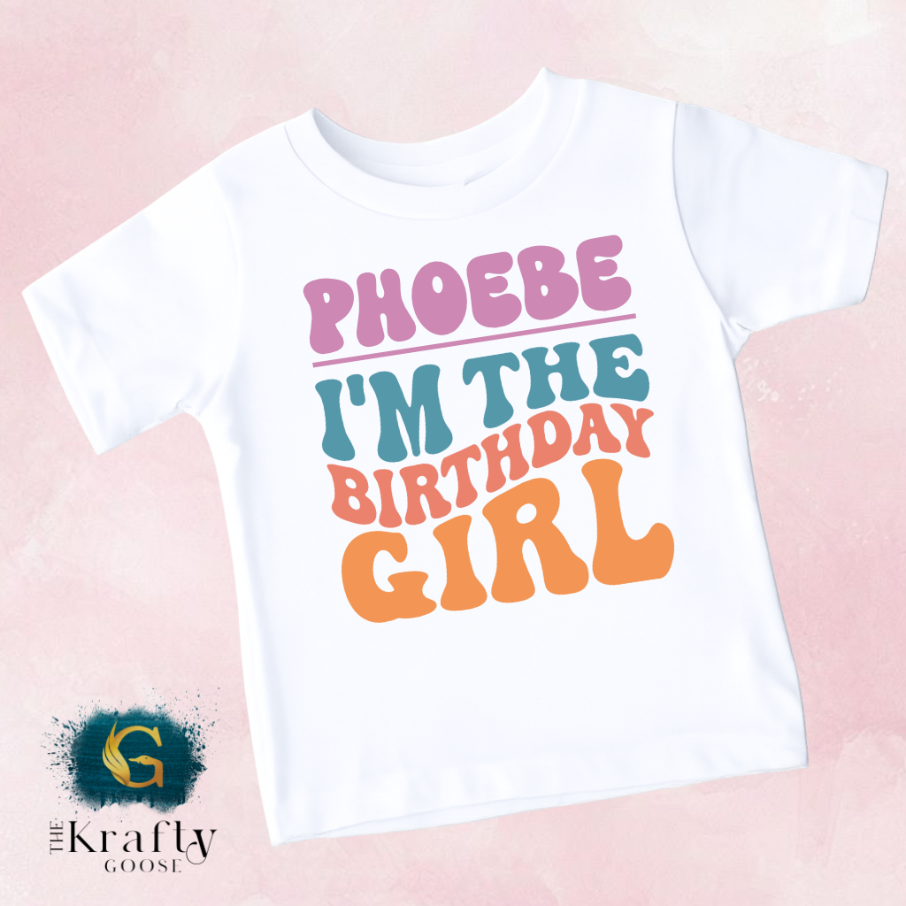 A white t-shirt with the text "PHOEBE I'M THE BIRTHDAY GIRL" printed on it.